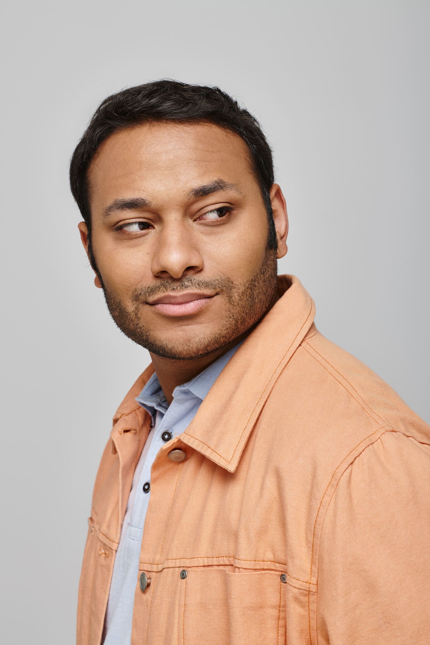 joyous indian man in vivid orange jacket smiling h 2024 11 08 16 57 42 utc